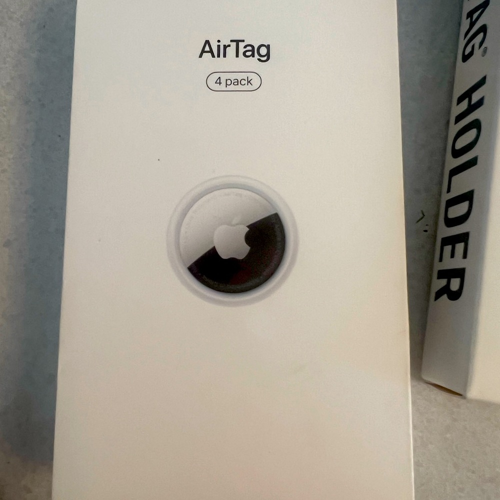 four pack of AirTags brand new inbox also AirTag holders for pack.